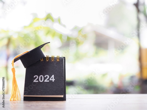 Study goals, 2024 Desk calendar with graduation hat. The concept for Resolution, Goal, Action, Planning, and manage time to success graduate.