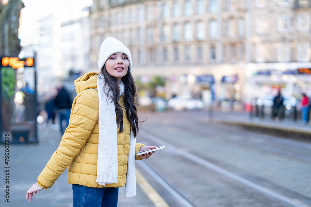 Outdoor portrait of a happy woman using a mobile phone at a bus stop People Lifestyle concept Outdoor portrait of a happy woman using a mobile phone at a bus stop People Lifestyle concept