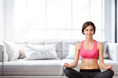 Young female meditating sitting at home