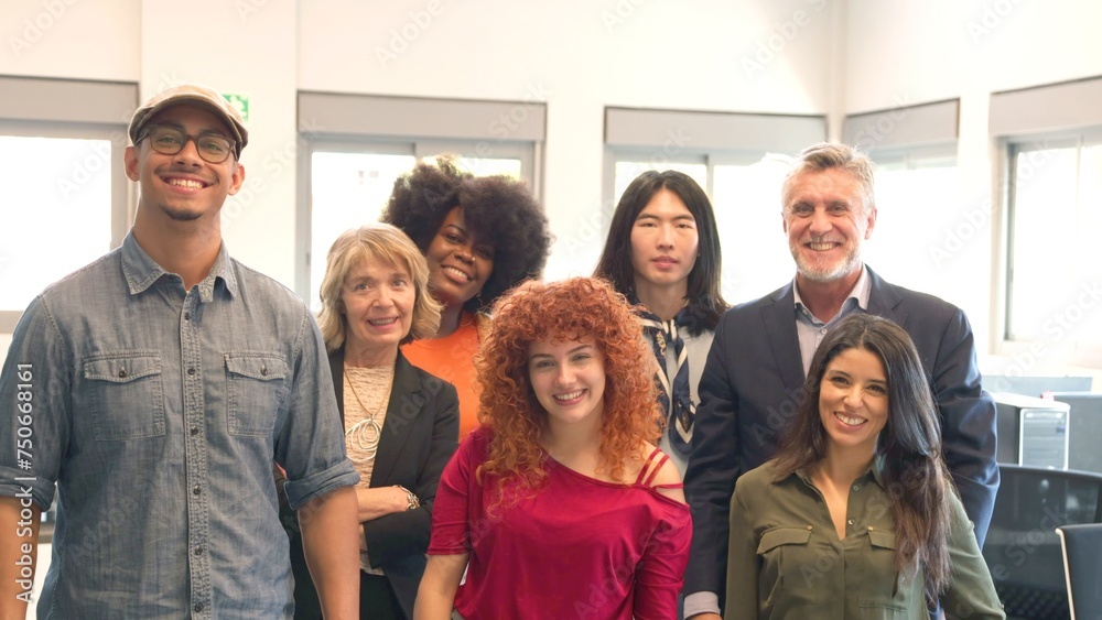 group of smiling multiracial office mates looking at the camera group of smiling multiracial office mates looking at the camera