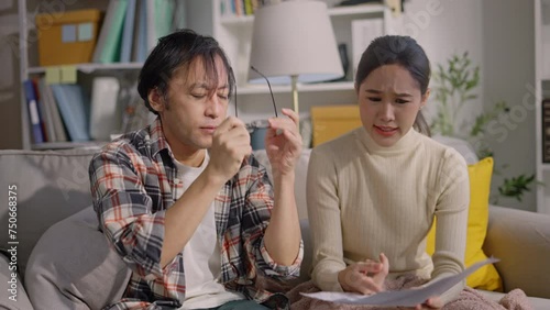 upset asian couple counting overspent budget,Unhappy young woman feeling stressed calculating monthly expenses at home,lack of money for utility household or rental payments, bankruptcy concept photo