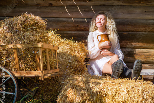 Beautiful blonde girl in the hayloft