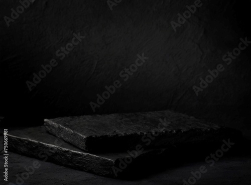 Black stone platform with dark background to display product and space for text.