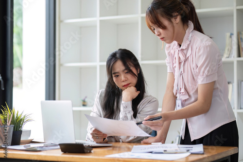 Two business people talk project strategy at office Businessman discuss project planning with colleague at modern workplace while having conversation and advice on financial data report