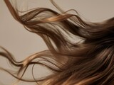 Super slow-motion shot capturing the elegant flow of wavy brown hair, highlighting texture and movement
