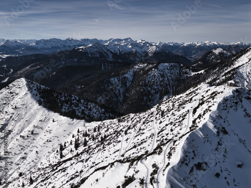 Drone shots at Herzogstand in Bavaria near the Alps, with snow-covered mountains, lakes and landscapes in the background photo