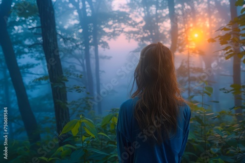Serene Sunrise in Misty Forest with Silhouette of Woman Enjoying the Peaceful Nature Scenery