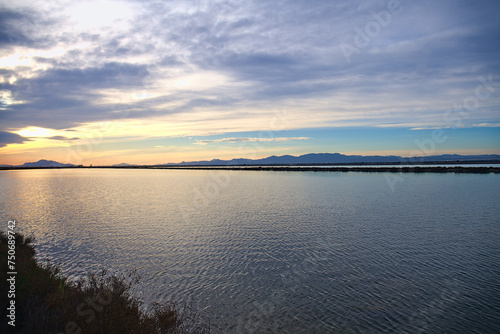 Sunset over saline lakes with Tamarit watchtower near Santa Pola  Spain  Europe