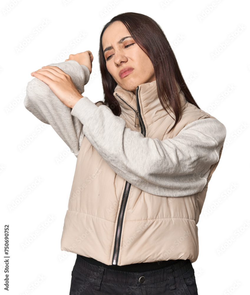 Modern young Caucasian woman portrait on studio background massaging elbow, suffering after a bad movement. Modern young Caucasian woman portrait on studio background massaging elbow, suffering after a bad movement.