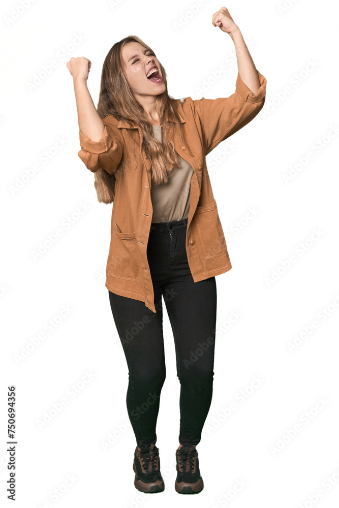 Studio portrait of a blonde Caucasian woman raising fist after a victory, winner concept. Studio portrait of a blonde Caucasian woman raising fist after a victory, winner concept.