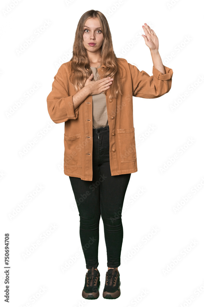 Studio portrait of a blonde Caucasian woman taking an oath, putting hand on chest. Studio portrait of a blonde Caucasian woman taking an oath, putting hand on chest.