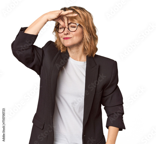 Caucasian woman in black business suit having a head ache, touching front of the face.