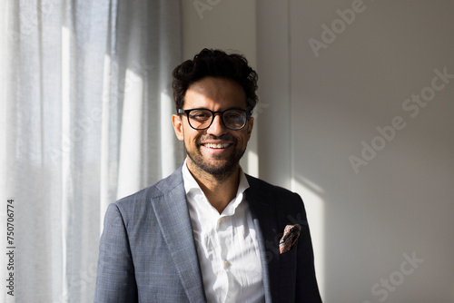 Portrait of smiling male real estate agent at new home photo