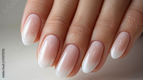 A hand with a classic French manicure.