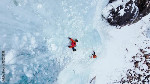 Ice climbing at frozen waterfall. photo