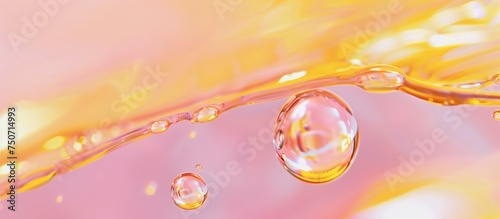 Moisturizer Clear Oil Bubble flothing under thin layer of oil and water in vibrant color ful pink and yellow rose gold background photo