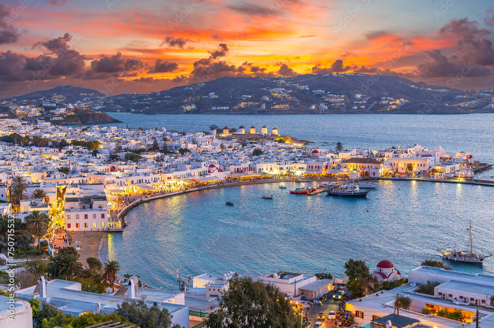 Embrace the warm hues of sunset in Mykonos Town Chora, where the Aegean Sea's azure waters reflect the vibrant life of this iconic Greek island. - obrazy, fototapety, plakaty 