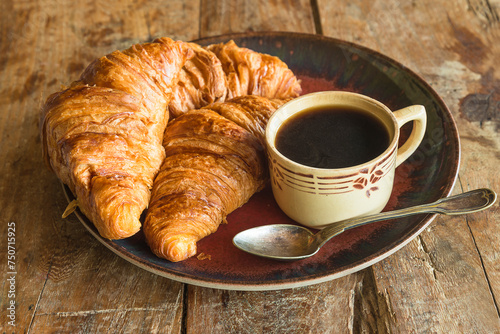 Fototapeta Naklejka Na Ścianę i Meble -  Traditional french breakfast: cup of coffee and hot croissants on a wooden background