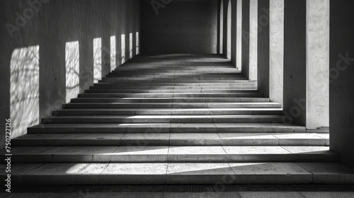 Black and white image capturing the stark contrast of shadows and light over a flight of outdoor stairs.