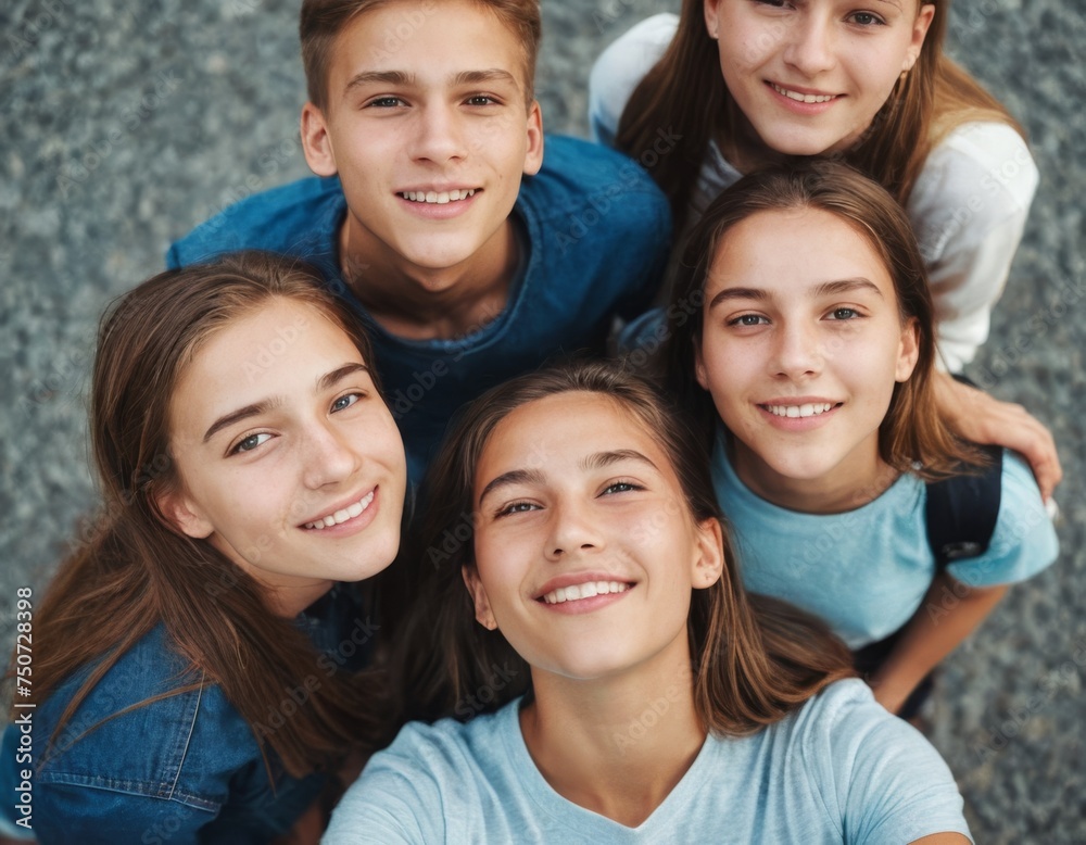 Fototapeta premium A group of young people are smiling and posing for a picture. Scene is happy and friendly