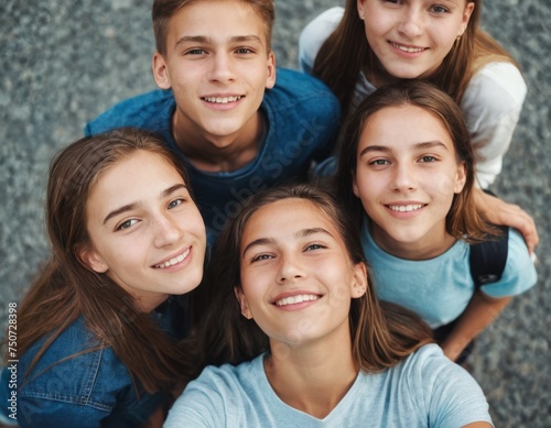 A group of young people are smiling and posing for a picture. Scene is happy and friendly