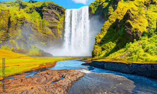 Icelandic Landscape concept - View of famous Skogafoss waterfall and amazing rainbow