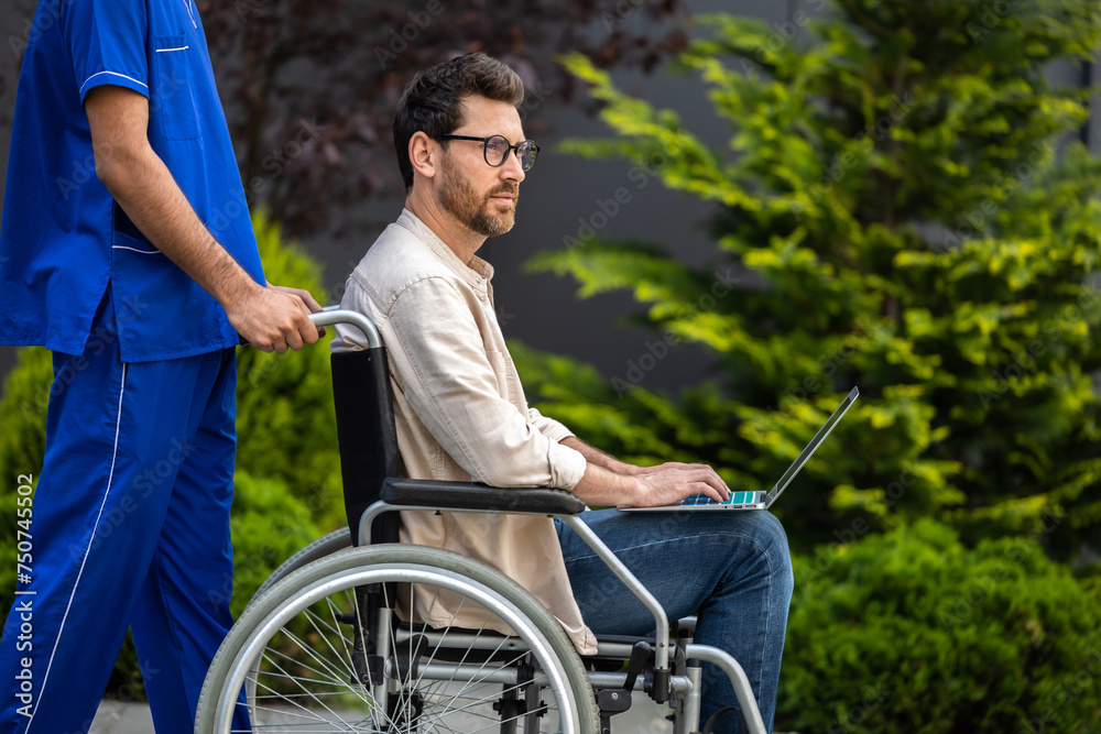 Male nurse in blue uniform carrying a wheelchair with male patient Male nurse in blue uniform carrying a wheelchair with male patient