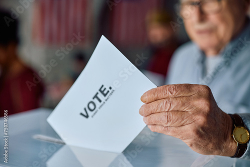 Close up of senior man voting during election day.
