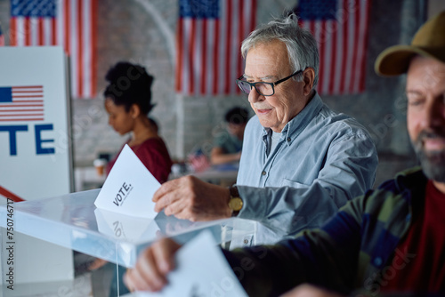 Senior citizen voting on US election day at polling place.