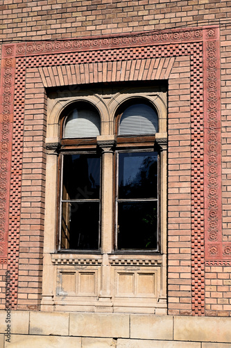 Medieval wooden decorative window in an old brick home