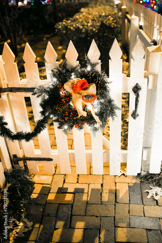 Christmas decoration on white fence.