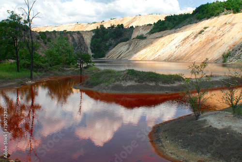 Red contaminated water due to heavy metals from copper tailings near copper mine