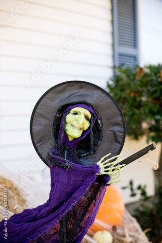Halloween witch with broom and hay.