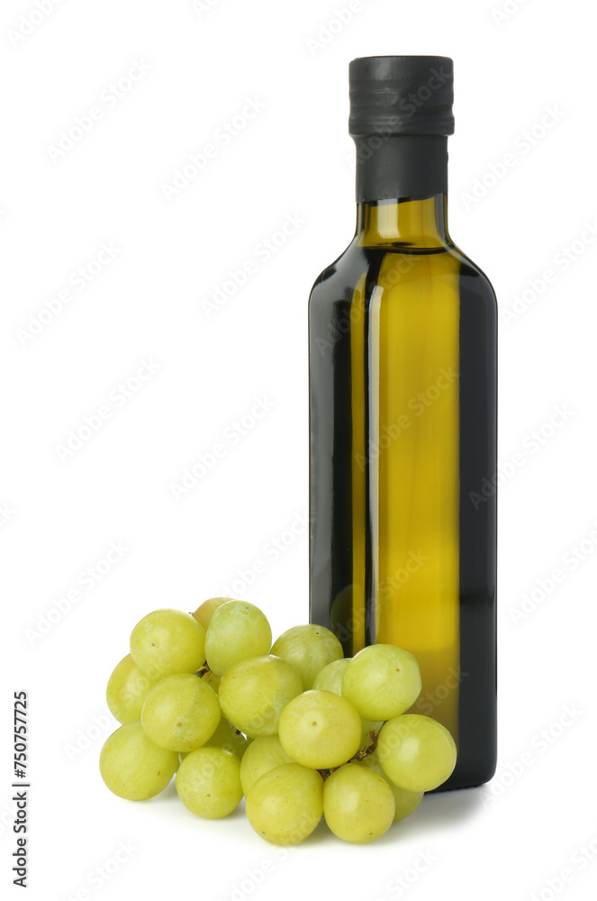 Vegetable fats. Bottle of cooking oil and fresh grapes isolated on white Vegetable fats. Bottle of cooking oil and fresh grapes isolated on white