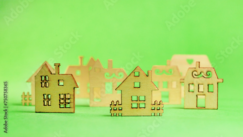 Model of the wooden house on green background. concept of sell of house, architecture. copyspace