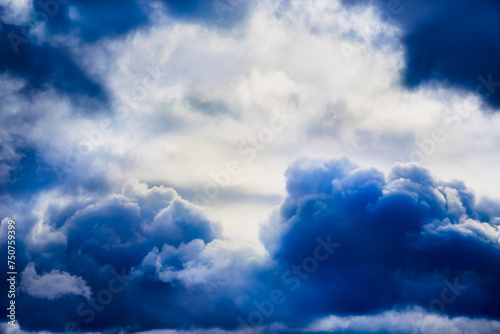 Close-up of stormy blue clouds in the sky, textured clouds on a blue sky.