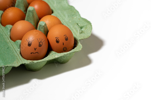chicken eggs with painted faces on white background, top view