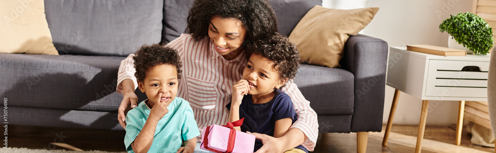 merry beautiful african american woman posing with her little two sons with present, Mothers day merry beautiful african american woman posing with her little two sons with present, Mothers day