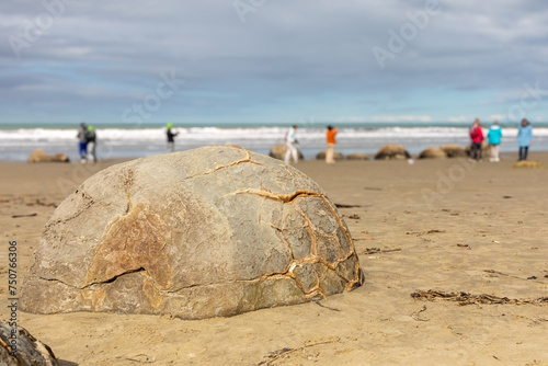 A stretch of Koekohe beach featuring the mysterious Moeraki boulders on the east coast of the South Island of New Zealand. The large boulders, on the Otago coast, are unusually spherical.