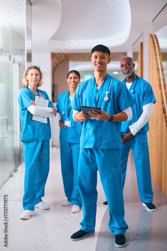 Obraz na płótnie Portrait Of Smiling Multi Cultural Medical Team Wearing Scrubs In Modern Hospita