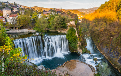 Jajce  town and waterfall in Bosnia and Herzegovina, Europe. Beautiful Pliva waterfall under the old town city in the autumn evening. photo