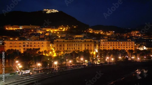 drone, vista notturna dal mare del lungomare di Salerno, mare, palazzi e castello Arechi sul fondo photo