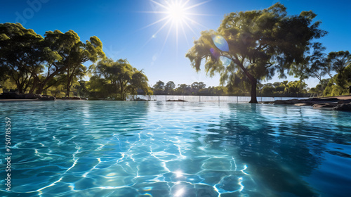 a pool with trees and a sunny sky