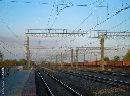 View of the railway and infrastructure and power lines at sunset