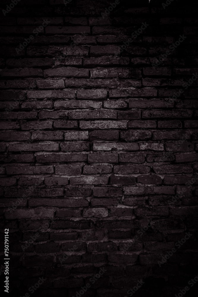 Vertical Black brick walls that are not plastered background and texture. The texture of the brick is black. Background of empty brick basement wall.