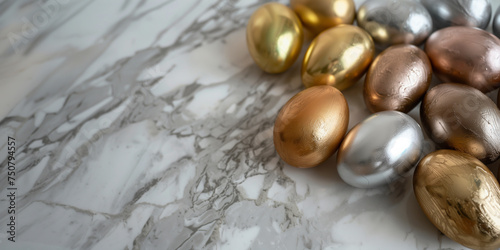 Metallic Easter eggs in gold, silver, and copper tones arranged on a marble countertop