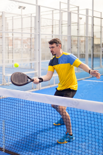 Open Tour template. Padel tennis player on the blue court background outdoors. Paddle tenis template for bookmaker design ads with copy space. Mockup for betting advertisement. Sports betting on tenis © Mike Orlov