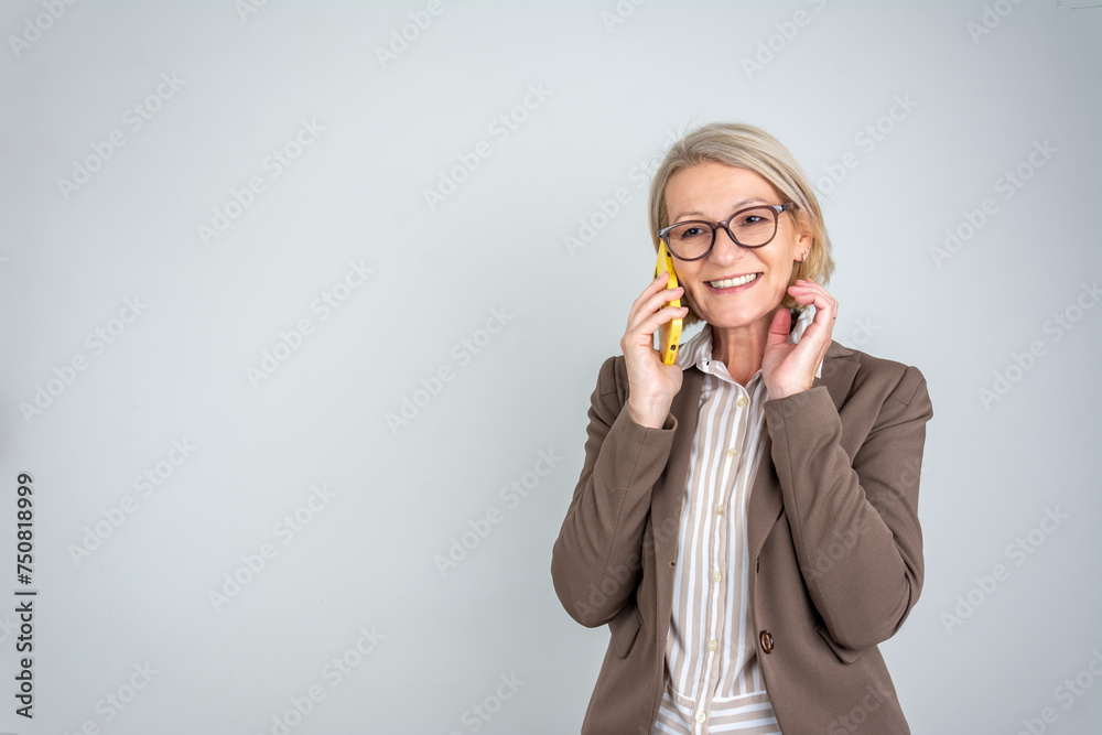 cheerful business woman talking on the phone isolated over grey background cheerful business woman talking on the phone isolated over grey background