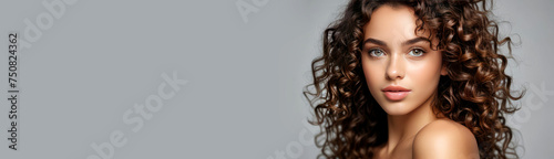 Model girl with shiny smooth healthy hair with curly hair and glowing, tan skin natural beauty smooth skin for Care, and hair and skin care products