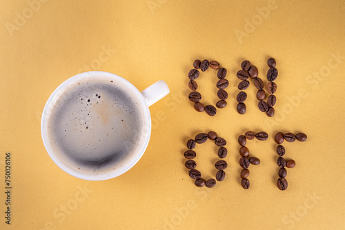 Waking up, turning on brain, setting it to work, concept of energy from coffee, charging with caffeine. Simple white espresso coffee cup with On and Off lettering made of coffee beans top view
